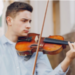 Violin teacher giving private lessons to a student, exploring the possibility of making a living from teaching violin.